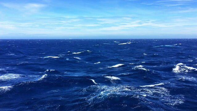 Deep blue ocean during the day with rough seas