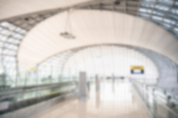 Blurred image of an airport termial. An airport terminal is a building where passengers depart on a...