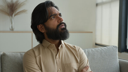 Thoughtful man Arabian muslim guy think idea indian male homeowner looking away dreaming thinking...
