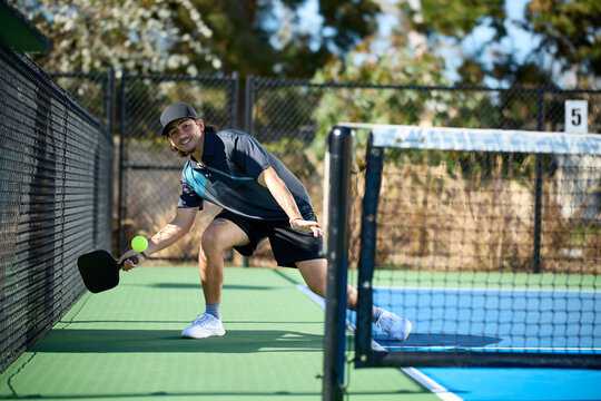 A pickleball player hitting an "ATP" shot