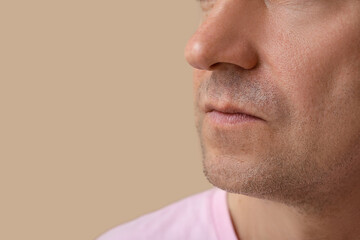 Obraz premium Mature man on brown background, closeup