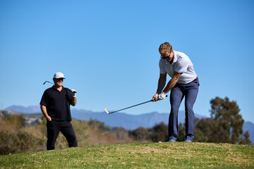 Two men play golf together 