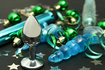 Sex toys with Christmas decor on black background