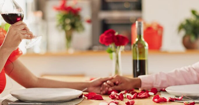 Couple, hands and toast with wine glass for home celebration of love, romance and valentines day on anniversary. People, table and date success with red champagne, drinks or luxury dinner with roses