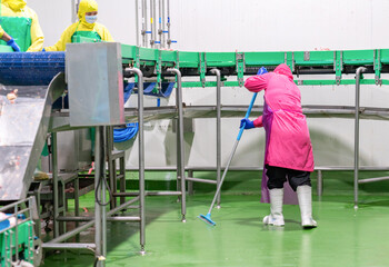The Cleaning staff uses a mop to clean the floor.