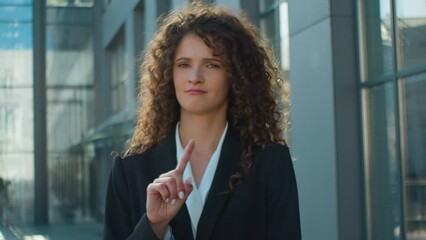 Confident woman Caucasian business girl in city serious looking at camera shaking finger prohibit warning gesture stop no never warn refuse deny female dissatisfied businesswoman waving hand forbid