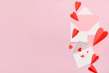 Envelopes with blank cards and red paper hearts on pink background. Valentine's Day celebration