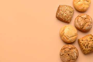 Different delicious buns on beige background