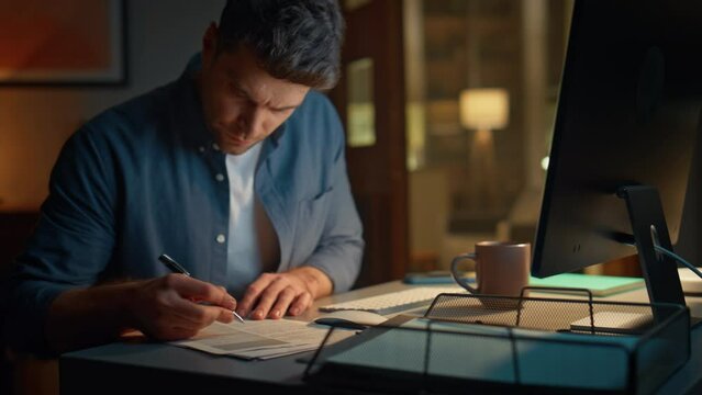 Busy man typing computer working at desk night closeup. Businessman making notes