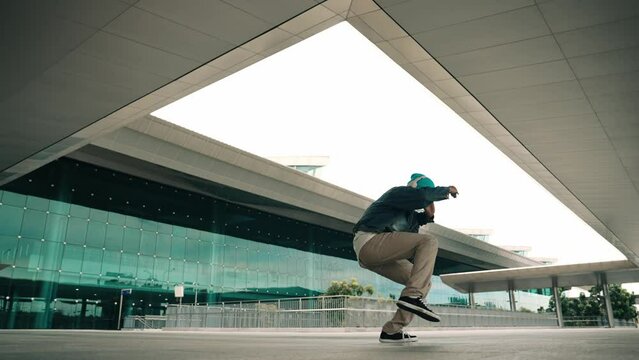 Panorama shot of happy hipster dance together while listen music from headphone at mall. Professional break dancer enjoy perform b boy footstep. Outdoor sport 2024. Modern street dancing. Sprightly.