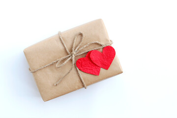 Brown gift box and red paper heart on white background