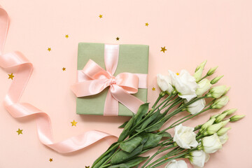 Gift box with beautiful white eustoma flowers and ribbon on pink background. International Women's Day
