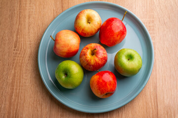 delicious apples on a wooden table, bitten apple, red apple and green apple