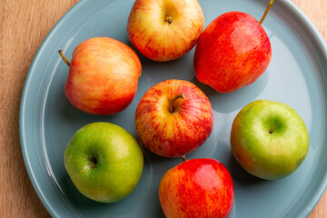 delicious apples on a wooden table, bitten apple, red apple and green apple