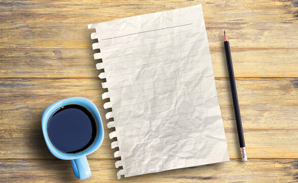 Top view blank paper, pecil and coffee cup on wood table background.
