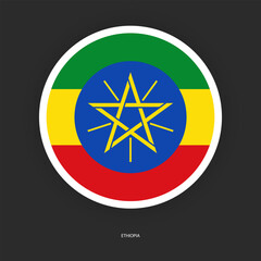 Ethiopia circle flag icon with white border isolated on dark grey background. Ethiopia circular flag icon on barely dark background.