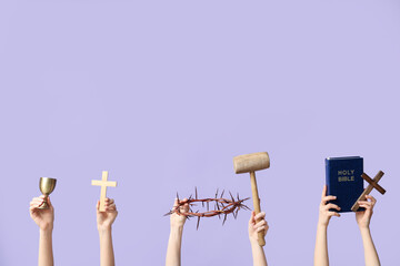 Female hands with crosses, crown of thorns, mallet and Holy Bible on lilac background. Good Friday...