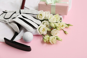 Composition with golf club, glove and beautiful flowers on pink background, closeup. International...