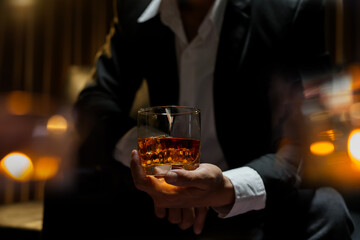 businessmen holding a glass of whiskey