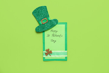Festive postcard with words HAPPY ST. PATRICK'S DAY and leprechaun hat on green background