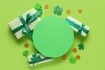 Blank card with gift boxes and decor for St. Patrick's Day celebration on green background