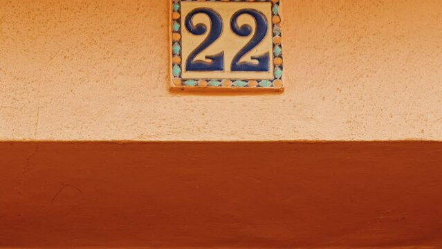 Number 22 (twenty-two) affixed to the exterior of a building, with an elegant, vintage and traditional appearance