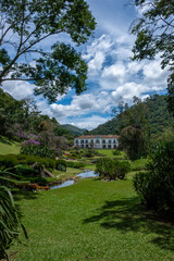 Fazenda Marambaia, Rio da Janeiro, Brazil, Elegant colonial-style manor surrounded by a lush Burle Marx-designed garden, featuring vibrant flowers and a tranquil pond