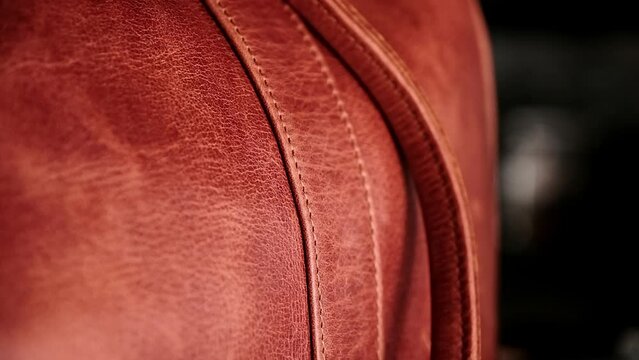 Details of a hand crafted caramel leather bag with neat stitching