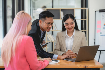 Group of Asian team business talking and planning with colleagues at a meeting. Business strategy planning concept.