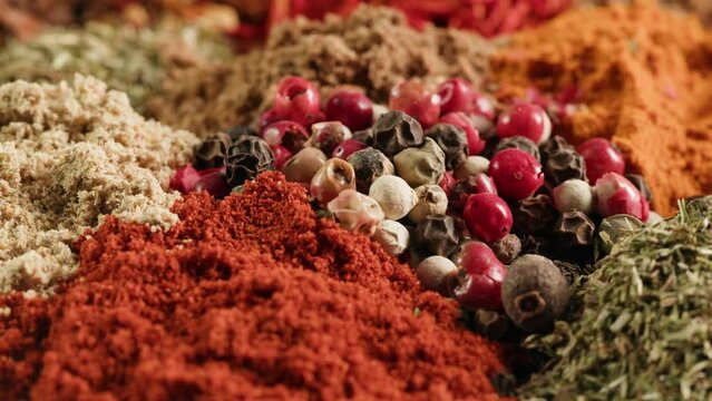 Mix spices dried pink, black pepper, green dill, red paprika, yellow turmeric, garlic, salt close-up macro. A bunch of natural spice for food .Seasonings and condiments concept