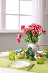 Beautiful table serving with red tulips for Easter celebration
