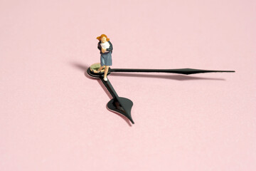 Miniature tiny people toy photography. A girl student wearing school uniform running above...
