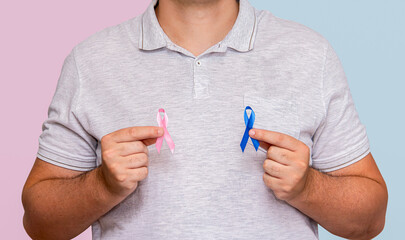 Man holding two Pink and Blue bows for the Pink October and Blue November campaigns to support life...