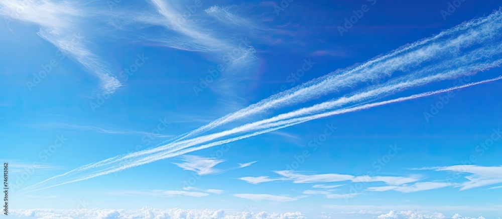 Poster Several airplanes are seen flying in formation through a clear blue sky, leaving distinct contrails behind them. The aircraft are soaring at high altitudes, showcasing the beauty of flight.