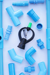 Sprinkler with blue pvc pipe connections for plumbing work.