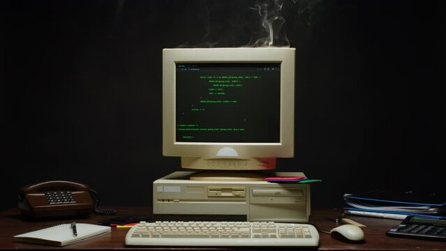 Retro pc with smoke on monitor with loading code console, programmer making scripts, green basic screen, Old computer studio close-up, Desktop vintage retro wave display, late 90s PC.