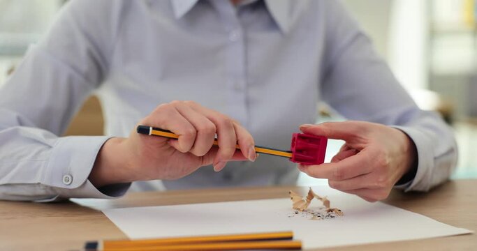 Closeup hand woman hands using pencil sharpener
