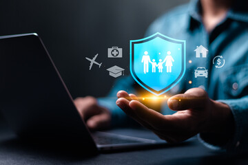 Online insurance concept. Person use laptop with online insurance icon on virtual screen for car, family and life, financial and health insurance.