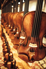 long set of violins on stand