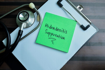 Concept of Hidradenitis Suppurativa write on sticky notes with stethoscope isolated on Wooden Table.