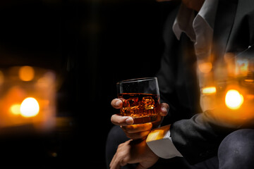 Closeup businessmen holding a glass of whiskey