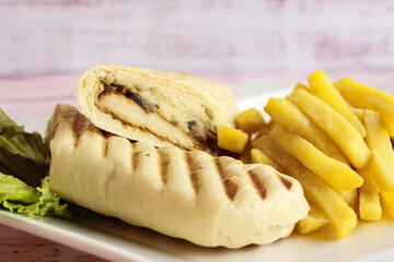 POTENTI PANINI Sandwich with french Fries served in dish isolated on table closeup side view of fastfood