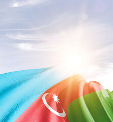 Azerbaijan flag in waving in beautiful sky with sunlight.
