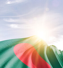 Bangladesh flag in waving in beautiful sky with sunlight.