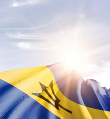 Barbados flag in waving in beautiful sky with sunlight.