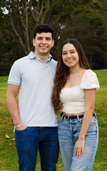 Obraz premium A beautiful young wedding couple taking a picture in a park
