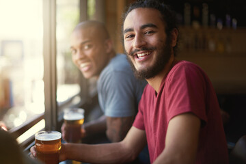 Male people, beer and chill at pub, smile and relax indoor for fun and bonding in summer to...