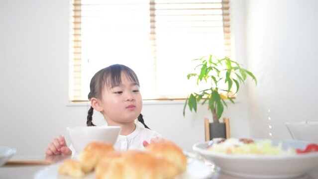 Video of front view of Asian (Japanese) girl eating Delicious~!