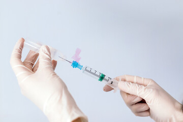 hands with syringe injecting serum