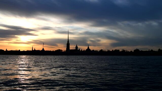 The Neva River and the silhouette of the Peter and Paul Fortress on a cloudy May evening. Saint Petersburg. Russia